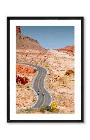 motorcycle riding in Valley of fire State Parkt on empty highway in scenic landscape