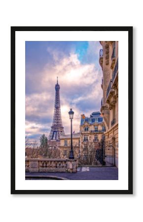 Paris, France - November 24, 2019: Small paris street with view on the famous paris eiffel tower on a cloudy day with some sunshine