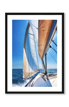 Sailing boat at open sea on a bright sunny day, vertical