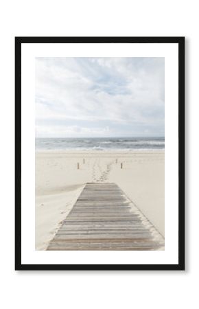 Beautiful beach with a wooden walkway to the ocean in cloudy weather