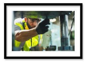 Close up hand industrial industrial plant with a tablet in hand, Engineer looking of working at industrial machinery setup in factory.