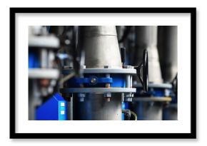 Large industrial water treatment and boiler room. Piping, flanges, butterlfy valves, rusty and corroded bolts. Industry, technology, special equipment, chemistry, heating, work safety. Panoramic view