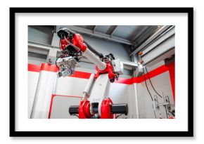 Low angle view of industrial welding robot arm in factory