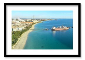 Panoramic shot of Kwinana alumina refinery on a sunny day with industrial plant and docked ship