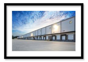 Exterior of modern distribution center warehouse at sunrise