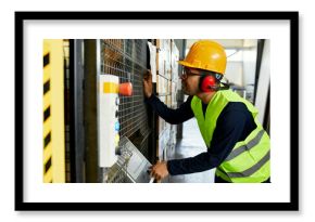 Man operating machine in industrial factory