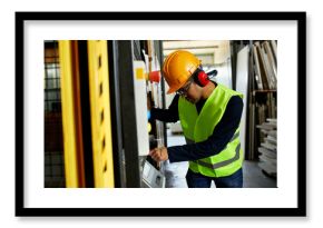 Man operating machine in industrial factory