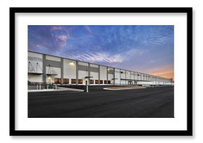 Modern warehouse distribution center at sunset