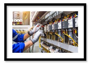 Electricity or electrical maintenance service, Engineer hand checking electric current voltage at circuit breaker terminal and cable wiring check in main power load center distribution board.