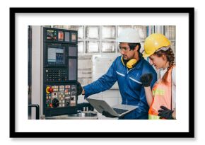 Male industrial engineer worker in hard helmet with female assistant using laptop control machine. Man and woman technician people working in heavy industry manufacturing factory.