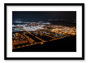 Aerial view of Leuna, Saxony at night with industrial complex and illuminated refinery, Saxony-Anhalt, Germany.