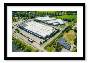 Aerial view of goods warehouse. Logistics center in industrial city zone from above. Aerial view of trucks loading at logistic center. View from drone.