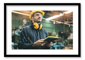 Industrial Engineers in Hard Hats.Work at the Heavy Industry Manufacturing Factory.industrial worker indoors in factory. man working in an industrial factory.Safety first concept.
