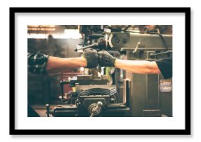 Experienced entrepreneurs, 2 engineers man Used hand for fist bump to show their cooperation For success teamwork, with blur soft of industrial machinery background, to people and synergy concept.