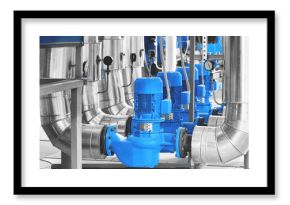 Modern industrial boiler room with pumps and pipe lines supplying steam with pressure gauges installed in. Blue toning. Panoramic banner.