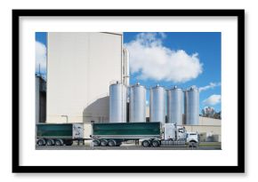 Tanker passing in front of large dairy industry towers in Australia