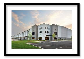 Modern gray warehouse distribution facility at sunrise