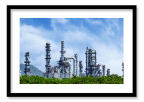 Oil refinery plant from industry zone, Oil and gas petrochemical industrial with tree and blue sky background, Refinery factory oil storage tank and pipeline steel, Ecosystem and healthy environment.