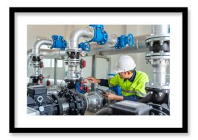 Asian worker at water supply stations inspect and maintain condenser equipment. Pumps in power substations for supplying clean water in industrial estates. Industrial plumbing.