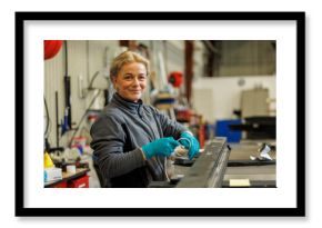Young female industrial worker working in factory