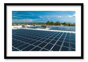 Aerial view of blue photovoltaic solar panels mounted on industrial building roof for producing clean ecological electricity. Production of renewable energy concept