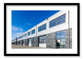 modern industrial building with loading doors and blue sky