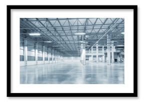 Concrete floor inside industrial building. Use as large factory, warehouse, storehouse, hangar or plant. Modern interior with metal wall and steel structure with empty space for industry background.