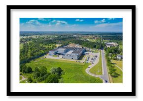 Aerial view of goods warehouse. Logistics center in industrial city zone from above. Aerial view of trucks loading at logistic center. View from drone