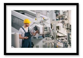 Man with helmet working in factory.