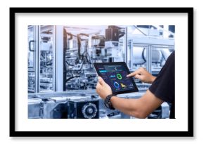 Smart industry control concept.Hands holding tablet on blurred automation machine as background