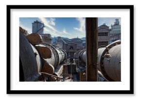View of storage aged containers with gas located on territory of industrial area in front of water towers and abandoned construction