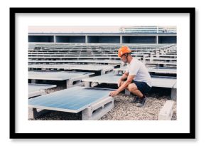 Serious male in helmet worker installing modern solar panels while working in industrial area of plant on sunny day