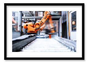 Blurred motion of robotic arm in factory