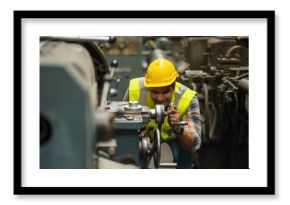 industrial Engineer indian man control lathe machine in industry manufacturing large factory . asian india labor worker male in hard hat and goggles working metal work in workplace . banner copy space