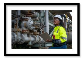 Engineers or industrial worker at large metal pipelines and valve systems oil refinery, chemical plant, or gas processing facility analyzing data is industrial safety, and operational efficiency.