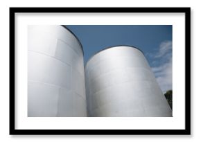 Two large, cylindrical storage tanks with a flat top.