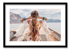 fashionable young model in boho style dress on boat at the lake