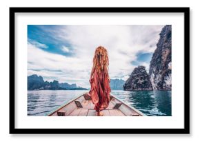 fashionable young model in boho style dress on boat at the lake