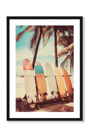 Surfboard and palm tree on beach background.
