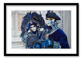 Person in Venetian costume attends Carnival of Venice.