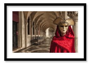 Woman with a red robe wearing a mysterious mask at Famous Venetian Festival
