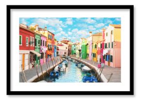Narrow canal and colorful houses in Burano, Italy.