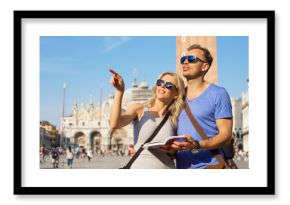 Couple reading tourist guide and sightseeing in Venice