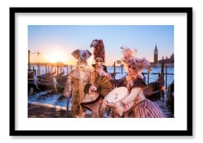 Carnival masks against sunrise in Venice, Italy