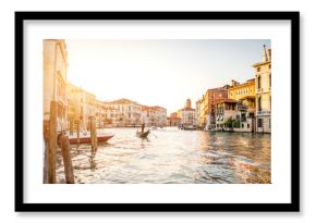 Venice cityscape view on Grand canal with colorful buildings and gondola floating on the sunset
