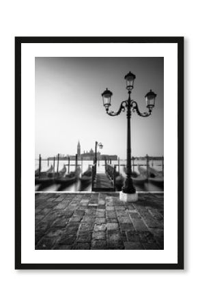 Gondolas at shoreline by Saint Mark square with San Giorgio di Maggiore church in the background, Venice, Italy, Europe
