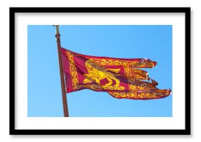 Red and gold flag of the city of Venice, Italy, the winged lion of  St Mark , on a blue sky