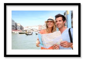Cheerful tourists with city map in Venice