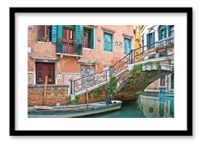 Bridge over a small canal, colorful and picturesque street in Venice, Italy