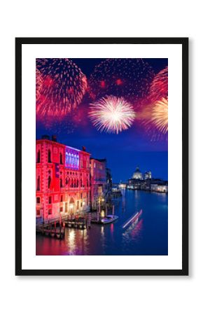 Pink and red lights with fireworks over the Grand Canal of Venice illuminated at night, Italy